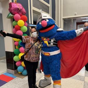 Super Grover poses for a picture 