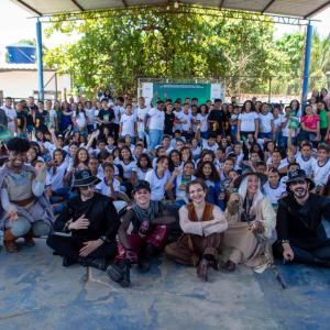 A seated group posed. Some in costumes in front.
