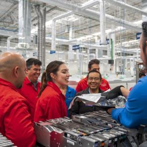 HARMAN team members shown in a factory.