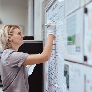HARMAN employee working on a white board.