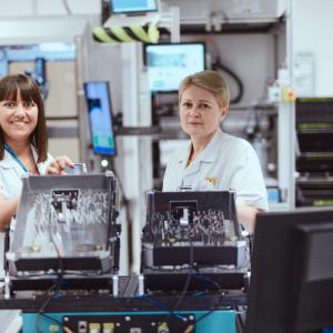 HARMAN employees shown with completed project.