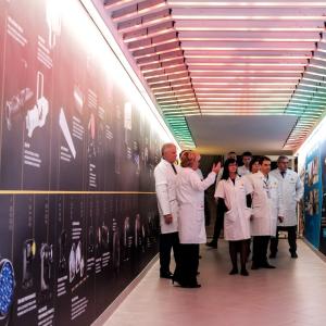 Tour of the new facility with a group of gowned individuals.