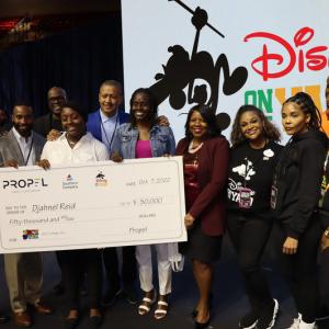 Djahnel Reid receiving a large check for her scholarship at HBCU Week event