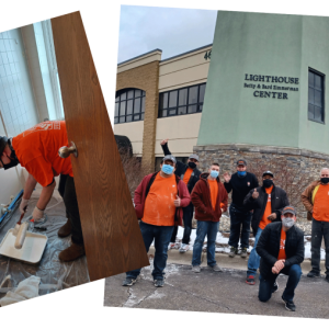 Home Depot volunteers standing in front of the lighthouse center. Eight volunteers wearing Home Depot t-shirts are featured.