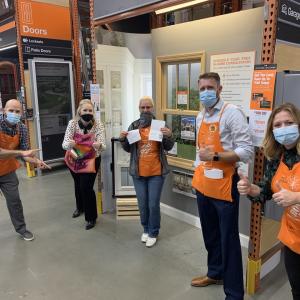 Kendra Byrd at her Home Depot store with four coworkers.