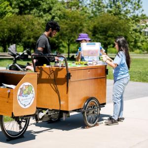 Group of people around a wooden cart