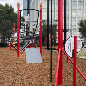 Red obstacle course with buildings in background