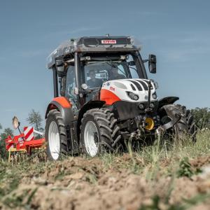 red tractor working in field