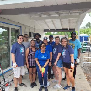 Group of volunteers standing together on porch