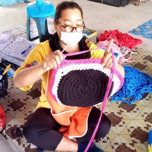 Thai woman knitting.