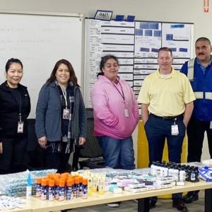 Group of teachers in the United States in front of a table. 