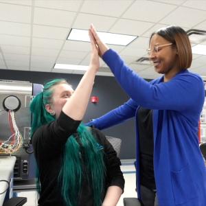 HARMAN Engineer Kelly giving a high-five.