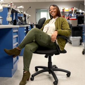 HARMAN Engineer Kelly sitting at her desk.