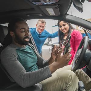 HARMAN employee testing out a car audio system.