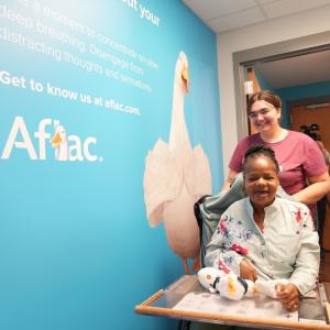 Harriet Gallman (front) and Montana Crosby, a recreation specialist with the Department of Disabilities and Special Needs, visit the new Aflac Wellness Room at the South Carolina State Museum.