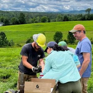 A group of people working together in a field 