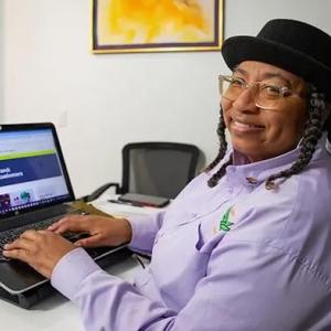 Helen Mathis working on a laptop