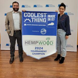 Two people holding winning banner