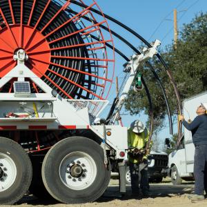 Vasquez works on a puller machine preparing to route underground electrical cables for a residential development.