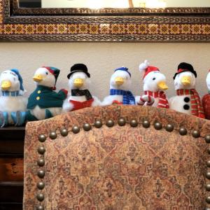 Collection of Aflac Holiday Ducks on a mantlepiece.