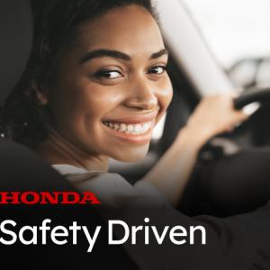 A person sat in the drivers seat looking over their shoulder 