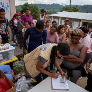 Action Against Hunger workers register migrant families for assistance.