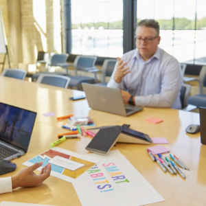 People sat at a table working on laptops