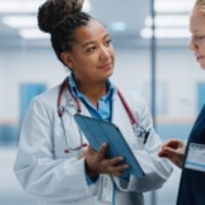 Female doctor and patient shown in consultation.