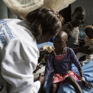 a doctor helps a young child