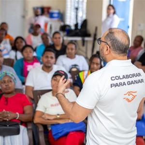 Instructor leading a financial literacy and mentorship session for community members in the Dominican Republic.