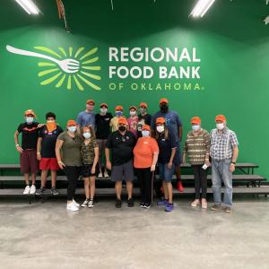 Oklahoma City employees take a timeout from preparing boxes of food and meals at the Regional Food Bank of Oklahoma on Sept. 17, 2022.