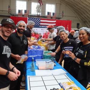 Volunteers from the LA Kings smiled as they packed meals for families in need.