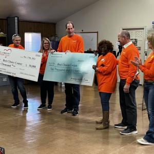 Volunteers holding a check