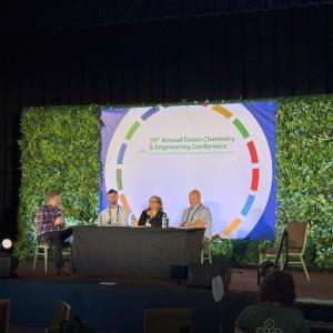 Four professionals on stage at the Annual Green Chemistry and Engineering Conference