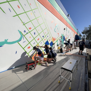 volunteers painting a mural