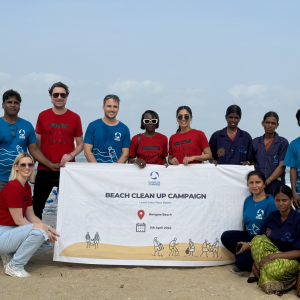 Volunteers pose with Beach clean up campaign banner