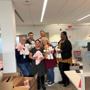 Covia employees pose with teddy bears for charities and hospitals