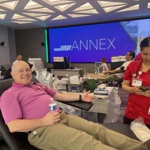 man smiling preparing to donate blood