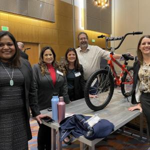 Arrow employees pose with a bike