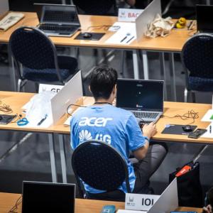 A participant with Acer laptop at IOI 2023