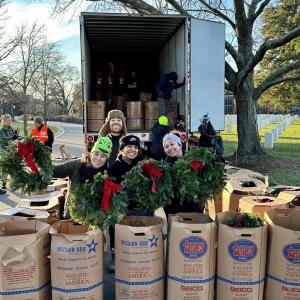 people holding up wreaths