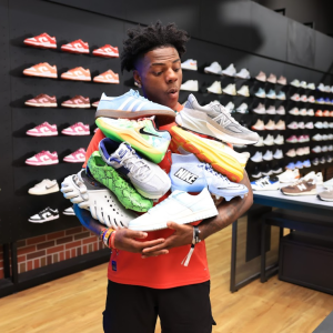 IShow Speed shown with an armful of sneakers.