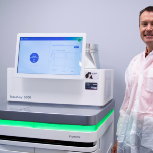 Daniel with the Illumina NovaSeq 6000, nicknamed "PoppySeq" at the PetDx offices.