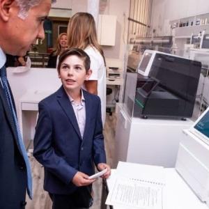 BizTown pictured in front of an Illumina sequencer.