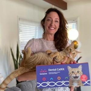 Anna Skaya holding her cat and a Dental CatKit