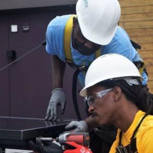 Workers installing solar panels.
