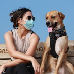 Rachel and her dog seated on a bench.