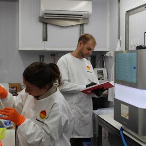 Two workers in a genomics lab.