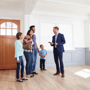 Photo of family touring a house for possible purchase.