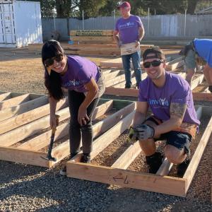 Volunteers help build a home
